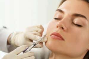 Woman closes her eyes during Restylane® injection